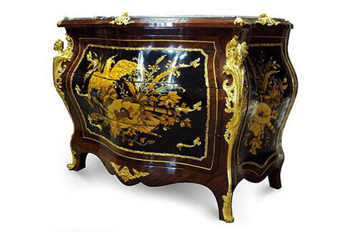 French Bombe Commode, French Louis XV style gilt-ormolu-mounted marquetry inlaid serpentine shape bombé chest of drawers, The serpentine shaped marble topped inset within a beveled frieze adorned with ormolu foliate pierced clasps on corners and center, above three drawers within a wide ormolu trim surrounded with another outer delicate strip and have foliate ormolu handles, The drawers are inlaid with exquisite marquetry woodworks of hunt and entertainment representing an eagle, hat, musical tools, leaves and branches, the sides has a similar marquetry design within ormolu borders, On each corner a beautifully crafted ormolu figurines of male and female on scrolls and pierced works extended with an ormolu band to the ormolu acanthus turned sabots covering the splayed legs, with fine foliate ormolu mount decorating the lower scalloped apron